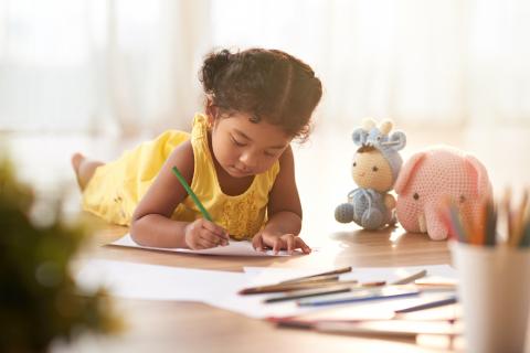 Girl coloring at table