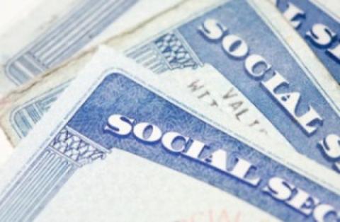 Image of social security cards stacked on top of each other.